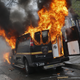 A Baltimore Metropolitan Police transport vehicle burns.